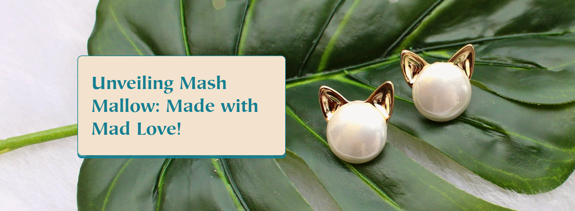 Mash Mallow pearl cat-ear stud earrings on green tropical leaf – cute and quirky artificial jewellery